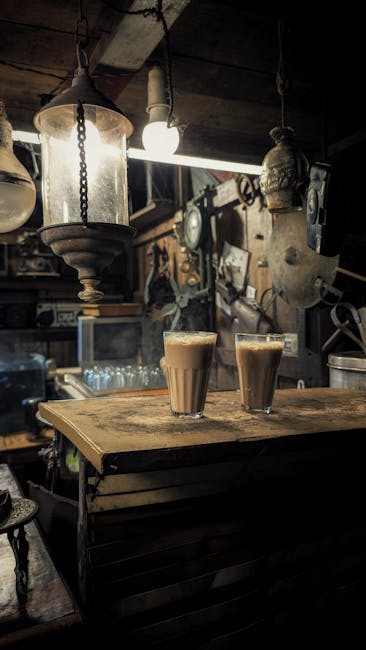 Warm, inviting cafe interior with vintage lamps and glasses of chai