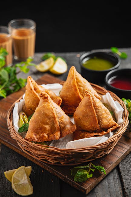 Golden samosas served with chutney